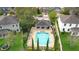 Aerial view of community pool and lounge area, surrounded by lush landscaping and ample seating at 2383 Regency Park Dr, Deland, FL 32724