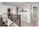 Second floor hallway with wood banister and access to additional rooms at 2383 Regency Park Dr, Deland, FL 32724