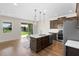 Modern kitchen with stainless steel appliances, center island, and sliding glass doors to the backyard at 2383 Regency Park Dr, Deland, FL 32724