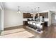Spacious kitchen with dark cabinets, stainless appliances, pendant lighting, and large island with seating for four at 2383 Regency Park Dr, Deland, FL 32724