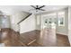 Open-concept living room with hardwood flooring, staircase, fan, and great natural light, offering a seamless flow at 2383 Regency Park Dr, Deland, FL 32724