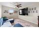Loft area showcasing a large television, comic book wall decor, and comfortable seating at 2383 Regency Park Dr, Deland, FL 32724