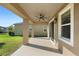 Covered patio area features a ceiling fan and access to the backyard, ideal for outdoor enjoyment at 2383 Regency Park Dr, Deland, FL 32724