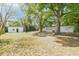 The large backyard has mature trees that provide shade and privacy, along with a detached storage shed at 2417 Healy Dr, Orlando, FL 32818