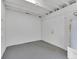 This is an unfinished basement with a white door and painted concrete floor at 2417 Healy Dr, Orlando, FL 32818