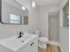 Bathroom with walk in shower, stylish mirror, white vanity, black hardware and wooden floors at 2417 Healy Dr, Orlando, FL 32818