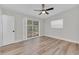 This bedroom is neutral and features wood floors, large windows, and a ceiling fan at 2417 Healy Dr, Orlando, FL 32818