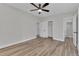 The bedroom offers wood-look flooring, a ceiling fan, a closet for storage and an ensuite bathroom at 2417 Healy Dr, Orlando, FL 32818