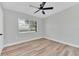 Bedroom featuring neutral paint, wood floors, large windows, and a ceiling fan at 2417 Healy Dr, Orlando, FL 32818