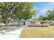 Charming single-story home featuring well-maintained landscaping, a covered carport, and a welcoming facade at 2417 Healy Dr, Orlando, FL 32818