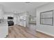 Open kitchen featuring stainless appliances and white cabinetry, seamlessly connected to the living space at 2417 Healy Dr, Orlando, FL 32818