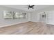 Bright living room featuring wood floors, neutral paint, large windows and a ceiling fan at 2417 Healy Dr, Orlando, FL 32818