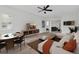 Open-concept living room with a white couch, mounted TV, modern furniture, and wood floors at 2417 Healy Dr, Orlando, FL 32818