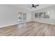 Neutral living room with wood floors, French doors, a ceiling fan, and large windows at 2417 Healy Dr, Orlando, FL 32818