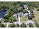 Aerial view of home near wooded area and neighborhood streets at 271 W 11Th St, Chuluota, FL 32766
