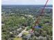 A quiet residential area surrounded by lush trees and clear skies as seen from above at 271 W 11Th St, Chuluota, FL 32766