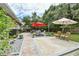 Spacious backyard featuring a paved patio area with an outdoor dining set, a lounge area and mature trees at 271 W 11Th St, Chuluota, FL 32766
