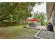 Fenced backyard features a patio with outdoor dining set at 271 W 11Th St, Chuluota, FL 32766