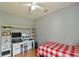 This bedroom offers a comfortable desk area and a bed with plenty of natural light at 271 W 11Th St, Chuluota, FL 32766