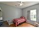 This bedroom offers a comfortable bed and a window with plenty of natural light at 271 W 11Th St, Chuluota, FL 32766