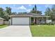 Charming single-Gathering home with a well-maintained lawn, lovely plants, and a two-car garage at 271 W 11Th St, Chuluota, FL 32766