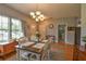 Inviting dining room with wood floors, seating for four, and a view of the front yard at 271 W 11Th St, Chuluota, FL 32766