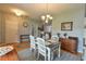 Bright dining room featuring stylish chandelier, four-chair table set, and beautiful wood floors at 271 W 11Th St, Chuluota, FL 32766
