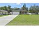 Charming single-story home with a long driveway, attached garage, and welcoming covered front porch at 271 W 11Th St, Chuluota, FL 32766