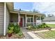 Charming front porch with tasteful decorations, plants, and a cozy seating area at 271 W 11Th St, Chuluota, FL 32766