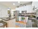 Eat-in kitchen features granite countertops, stainless steel appliances, and ample storage space in pristine white cabinets at 271 W 11Th St, Chuluota, FL 32766