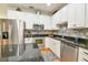 Modern kitchen with stainless steel appliances, granite countertops, stylish tile backsplash, and white cabinets at 271 W 11Th St, Chuluota, FL 32766