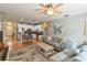 Open-concept living room with a sofa, island seating, and modern white kitchen cabinets at 271 W 11Th St, Chuluota, FL 32766