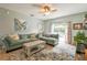 Comfortable living room with a plush sofa, a rustic coffee table, and access to the backyard at 271 W 11Th St, Chuluota, FL 32766