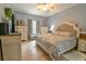 This primary bedroom showcases a decorative headboard, and an abundance of natural light at 271 W 11Th St, Chuluota, FL 32766