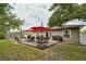 Paver patio features outdoor dining and a well-manicured lawn at 271 W 11Th St, Chuluota, FL 32766