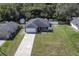 Aerial view of a well-kept house with a long driveway and large backyard surrounded by trees at 271 W 11Th St, Chuluota, FL 32766