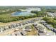 Aerial view of a neighborhood by a lake surrounded by trees at 2837 Darlington Oak Ln, Ocoee, FL 34761