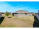 Spacious backyard featuring a well-maintained lawn and the side view of the home at 2837 Darlington Oak Ln, Ocoee, FL 34761