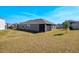 Side view of the home showcasing the spacious backyard and covered patio at 2837 Darlington Oak Ln, Ocoee, FL 34761