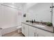Bathroom featuring double sinks, a bathtub with shower, and modern fixtures at 2837 Darlington Oak Ln, Ocoee, FL 34761