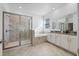 Bright bathroom featuring a large glass shower and soaking tub, complemented by dual sinks and modern fixtures at 2837 Darlington Oak Ln, Ocoee, FL 34761