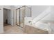 Bright bathroom featuring a large glass shower and soaking tub with modern fixtures at 2837 Darlington Oak Ln, Ocoee, FL 34761