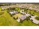 An aerial view of the community pool, clubhouse, surrounding neighborhood, and a manicured landscape at 2837 Darlington Oak Ln, Ocoee, FL 34761