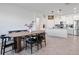 Open-concept design featuring a dining area with a modern kitchen and island in the background at 2837 Darlington Oak Ln, Ocoee, FL 34761