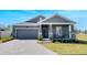 Beautiful one-story home with gray exterior, brick driveway, and cozy front porch at 2837 Darlington Oak Ln, Ocoee, FL 34761