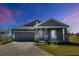Charming one-story home boasts a brick driveway, well-manicured lawn, and inviting front porch at 2837 Darlington Oak Ln, Ocoee, FL 34761