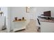 Bright hallway featuring wood-look tile floors, white walls, and decoratively appointed farmhouse table at 2837 Darlington Oak Ln, Ocoee, FL 34761