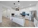 Modern kitchen featuring white cabinets, stainless steel appliances, and a large center island at 2837 Darlington Oak Ln, Ocoee, FL 34761