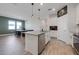 Bright, open kitchen with island seating, stainless steel dishwasher, and modern pendant lighting at 2837 Darlington Oak Ln, Ocoee, FL 34761
