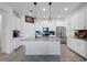 Contemporary kitchen with a central island, stainless steel appliances, and stylish pendant lighting at 2837 Darlington Oak Ln, Ocoee, FL 34761